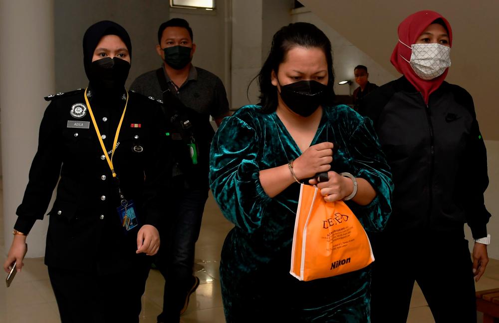 Woman claims trial to 4 counts of money laundering Woman claims trial to 4 counts of money laundering