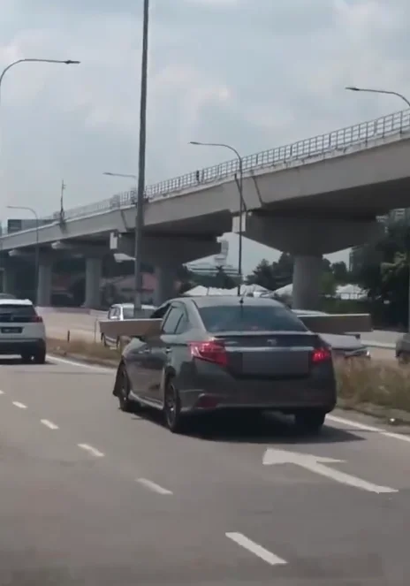 Driver slammed for carrying long wooden plank sticking out of both sides of car on busy road Driver slammed for carrying long wooden plank sticking out of both sides of car on busy road