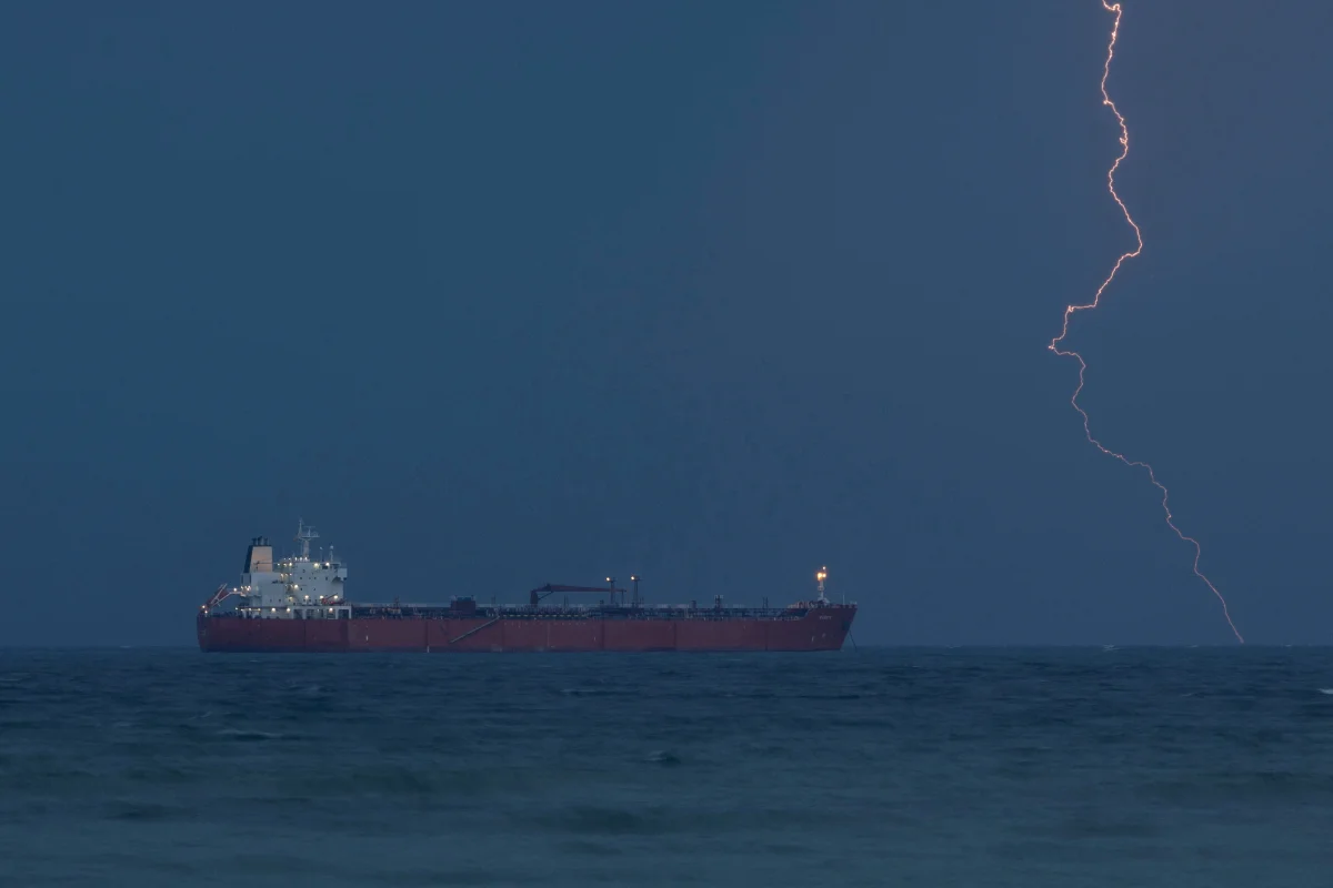 Iran's navy tells ships Strait of Hormuz shut again, two vessels report gunfire
