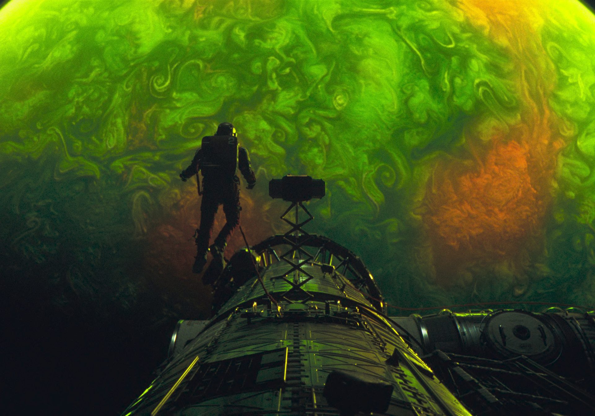 Lighting in the space sequences uses harsh, directional sources to mirror real conditions, with minimal reliance on green screen to preserve a more physical look.
