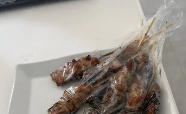 ‘Burnt fingers’ shock turns out to be satay packed in plastic glove