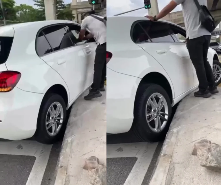 Strangers step in to help woman after car gets stuck on road divider