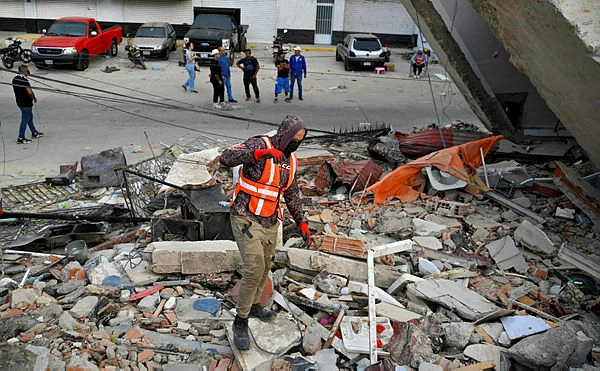 A painful wait by a pile of rubble in quake-hit Venezuela