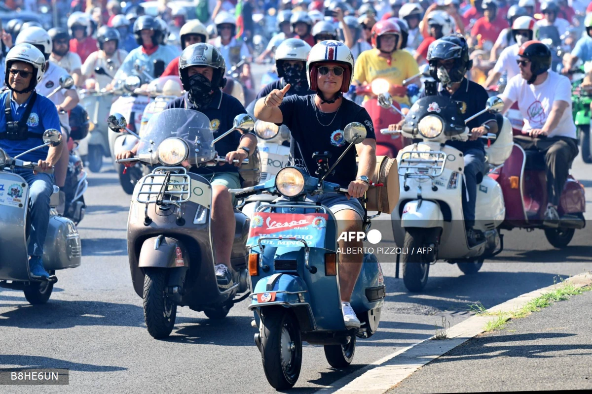 Vespa celebrates 80 years with thousands riding through Rome